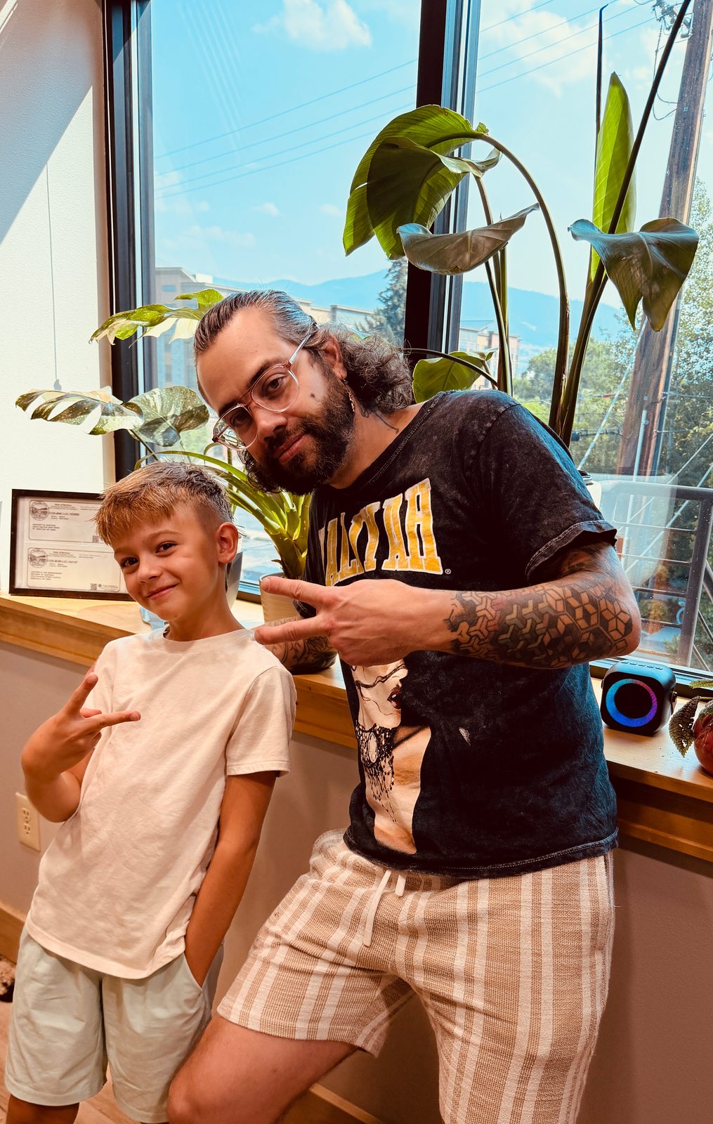 Barber Tony Santana with a young client after a kids haircut at The Barber Studio in Missoula