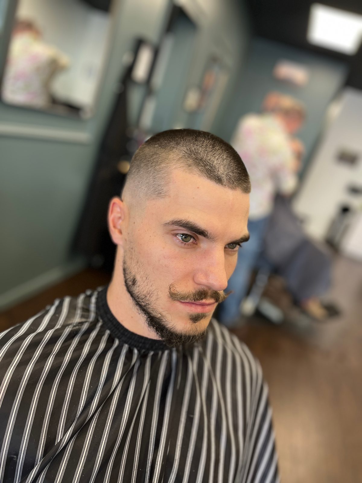 Buzz cut with a shaped mustache and sharp edge work, The Barber Studio Missoula MT