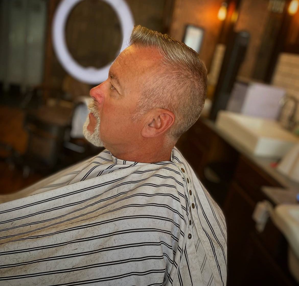 Grey pompadour with a shaped beard and razor lineup, Missoula barber shop