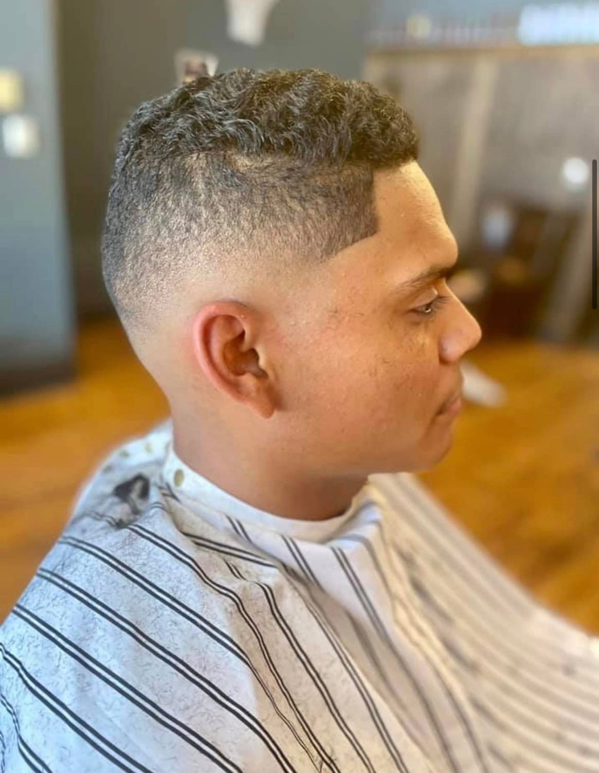 Short curly crop with a high skin fade, cut in downtown Missoula, Montana