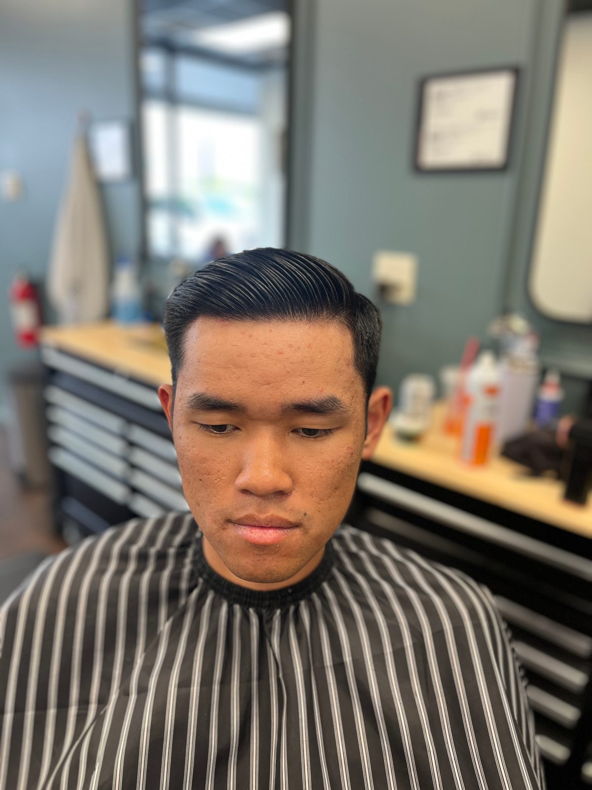 Slicked side part with a tapered fade, cut at The Barber Studio in downtown Missoula