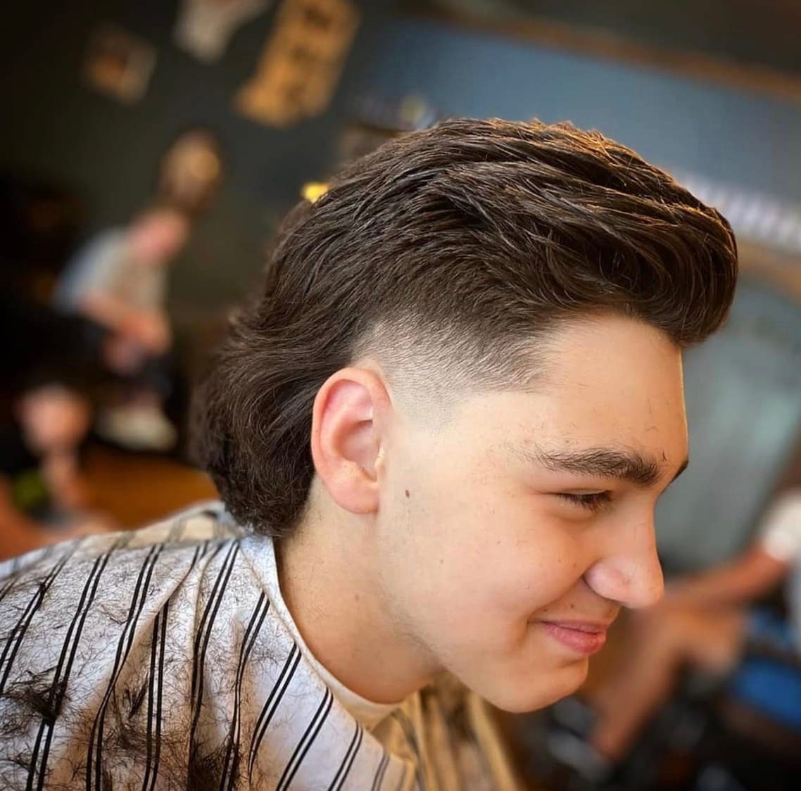 Textured pompadour with a skin fade on the sides, cut at The Barber Studio in Missoula